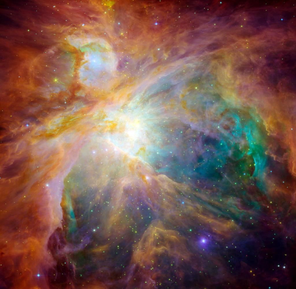 Diese auffällige Mischung aus Infrarot und sichtbarem Licht weist darauf hin, dass vier ungeheuer massive Sterne in der Mitte der Wolke die Hauptschuldigen in der berühmten Orion-Konstellation sein könnten.  Die Sterne werden zusammen als Trapez bezeichnet.  Ihre Community kann als gelber Fleck in der Nähe der Bildmitte identifiziert werden.