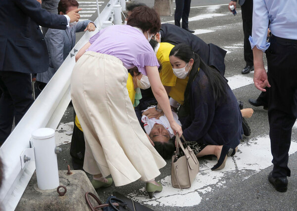 Shinzo Abe, the former prime minister of Japan, lying mortally wounded on the ground in Nara on Friday.